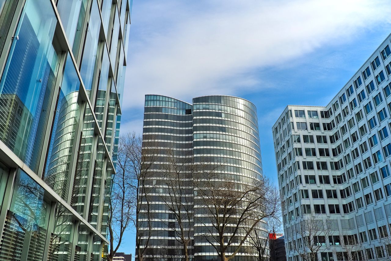 A striking view of modern skyscrapers against a clear blue sky, showcasing contemporary architectural design.